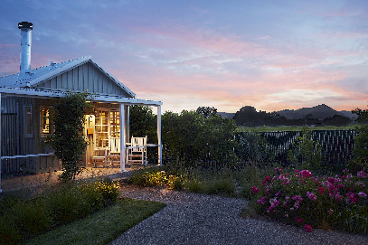 A small villa with a porch and a garden.