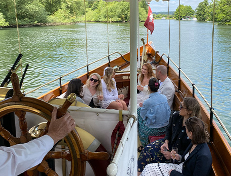 Wooden boat on water, people chatting