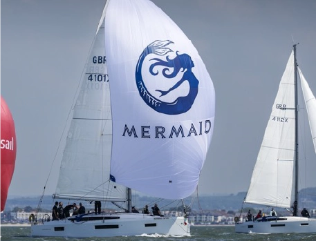 Mermaid Spirit yacht racing with its signature sail on the Solent waters, showcasing the vessel during a sailing event.